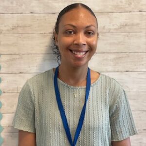 picture of school psychologist standing in front of a tan wall
