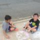 children coloring sidewalk with chalk