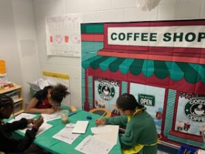 Students working in a small math group at a "Coffee Shop".