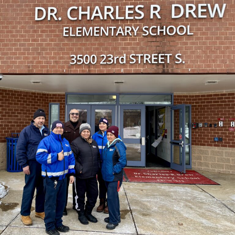 pic of custodians and Dr. Duran in front of Drew
